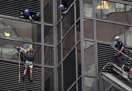 A man scales the all-glass facade of Trump Tower Wednesday Aug. 10 2016 in New York. A police spokeswoman says officers responded to Donald Trump's namesake skyscraper on Fifth Avenue in Manhattan. The 58-story building is headquarters to the Rep