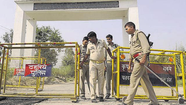 Policemen at the entrance of Bisada village where Mohammad Ikhlaq was lynched in Dadri