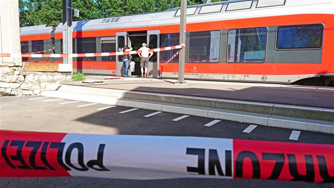 Policemen stand by a train at the station in Salez eastern Switzerland after a man stabbed passengers