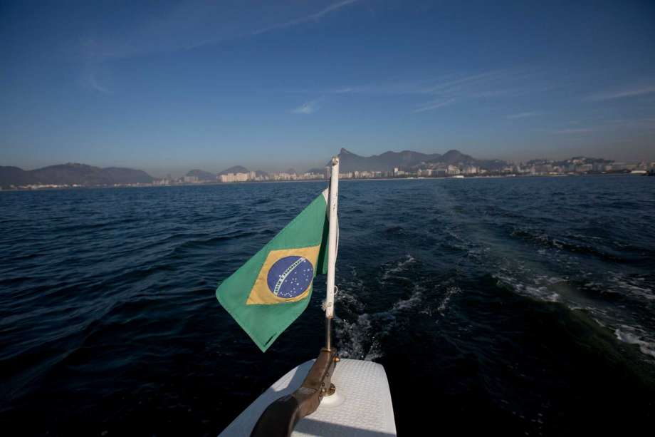 Brazil's national flag decorates the boat used to collect water samples from Guanabara Bay for an ongoing water quality study commissioned by The Associated Press in Rio de Janeiro Brazil. The AP published the first results