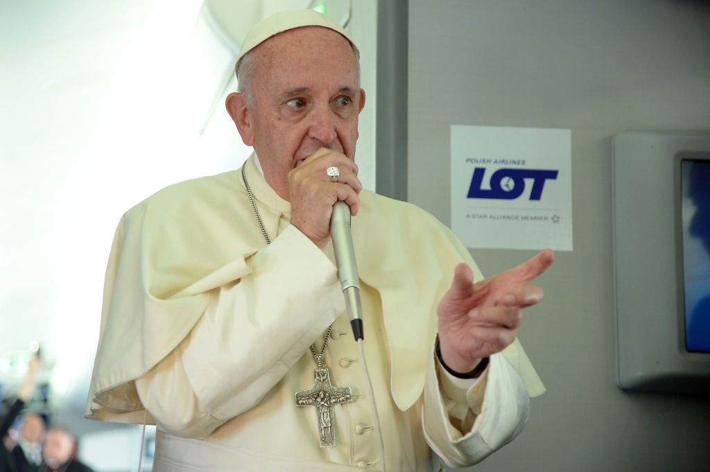 Pope Francis answers reporters questions on board the flight from Krakow Poland to Rome at the end of his 5-day trip to southern Poland Sunday