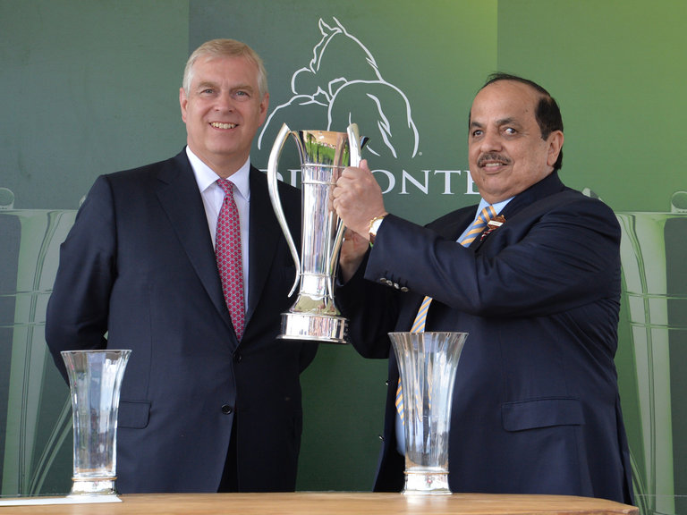 The Duke of York presents the trophy to the owner of Postponed Sheikh Mohammed Obaid Al Maktoum after winning the Juddmonte International Stakes