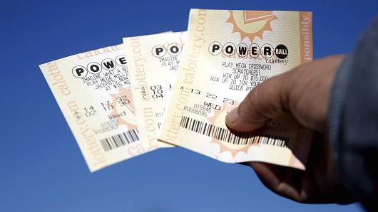 A woman holds Powerball lottery tickets outside Bluebird Liquor in Hawthorne Los Angeles California United States