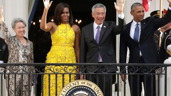 U.S. President Barack Obama and first lady Michelle Obama wave with Singapore