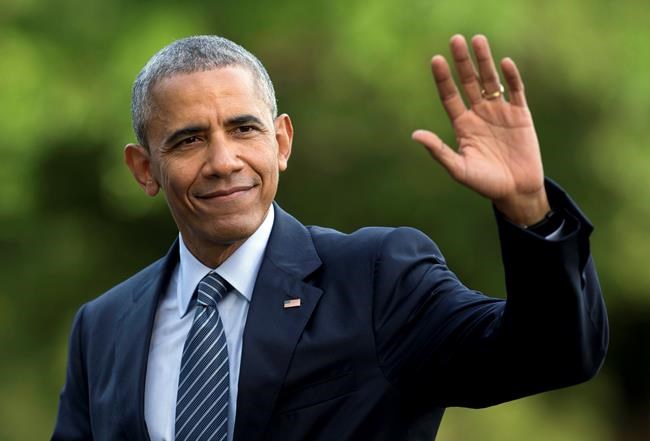 President Barack Obama waves as he walks across the South Lawn of the White House in Washington as he returns from Charlotte N.C. where he participated in a campaign event with Democratic presidential candidate Hillar