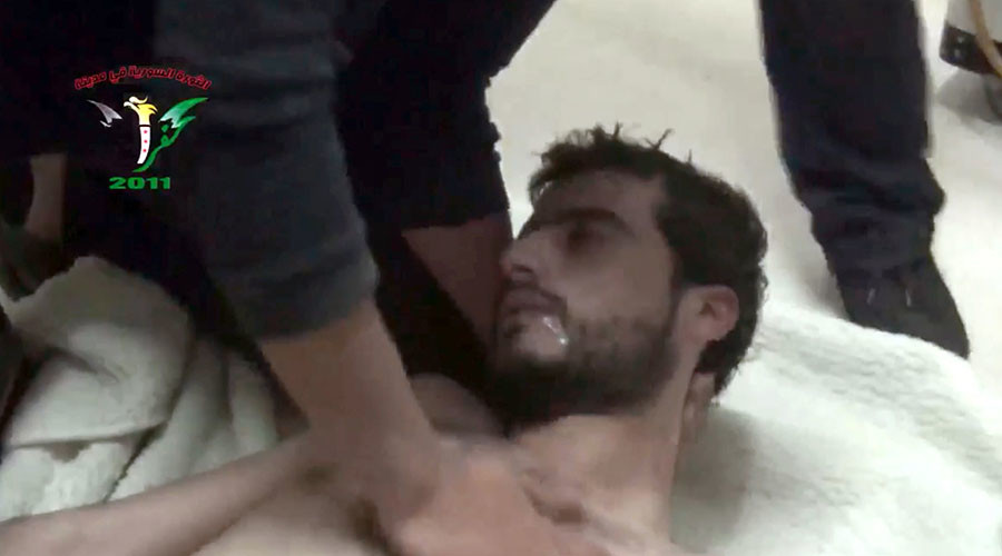 An image grab taken from a video released by the Syrian activist group Kafrzita shows a man being treated after purportedly chocking from inhaling poison released after a barrel bomb was allegedly dropped from an aircraft