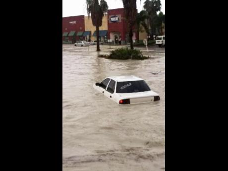 Pause   
      
    
    This car narrowly escaped being swept away as flood waters took over sections of Montego Bay St James yesterday.
            Harris