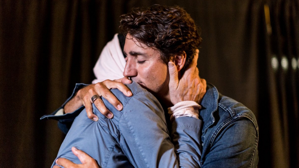 Prime Minister Justin Trudeau hugs Tragically Hip lead singer Gord Downie ahead of the band's final concert in Kingston Ont. 680 NEWS