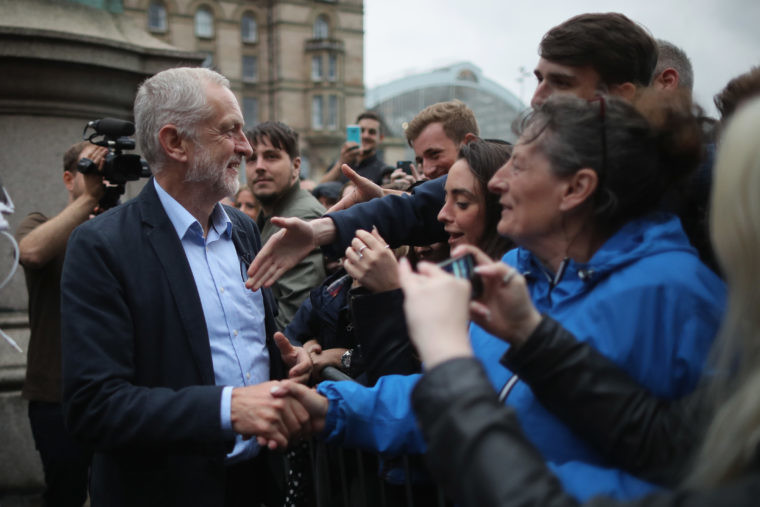 Labour Leader Jeremy Corbyn shakes hands with supporters after addressing thousands of people in St George's Square Liverpool