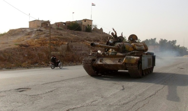 Pro-regime drive a tank in the Syrian northeastern city of Hasakeh where Kurdish forces are advancing