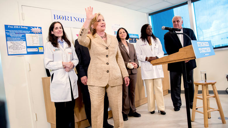 Democratic presidential candidate Hillary Clinton waves after speaking to medical professionals after taking a tour of Borinquen Health Care Center in Miami Fla. Tuesday Aug. 9 2016 to see how they are combatting Zika