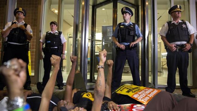 Protesters lie on the ground in front of the Chicago Police Department to protest against police brutality