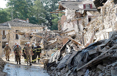 AMATRICE Italian firefighters and soldier walk amid ruins during operation aiming at reopening the road in Rio a little village near Amatrice central Italy two days after a 6.2-magnitude earthquake struck the region killing some 267 people and injuring