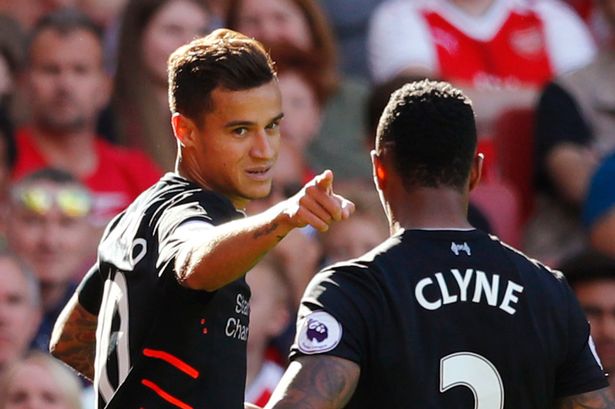 Liverpool's Philippe Coutinho celebrates scoring their third goal with Nathaniel Clyne