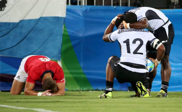 Vatemo Ravouvou celebrates with a teammate as Tom Mitchell reacts