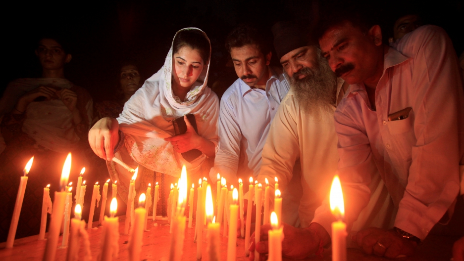 Residents light candles to honour victims of the blast in Quetta during a candellight vigil in Peshawar Pakistan.   
  Credit    Fayaz Aziz