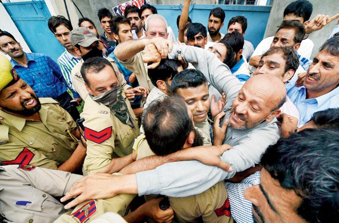 J&K police stop MLA Sheikh Abdul Rashid and members of Awami Itihaad Party who were holding a protest march against civilian killings in Srinagar yesterday. Pic  PTI