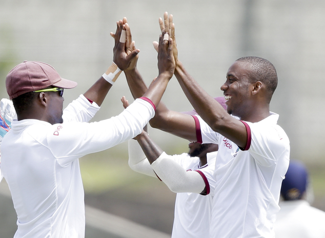 West Indies Miguel Cummins celebrates with teammates after taking the wicket of India's Ravindra Jadeja during day two of their third cricket Test match