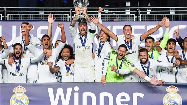 Real Madrid's Sergio Ramos lifts the trophy as they celebrate winning the UEFA Super Cup title