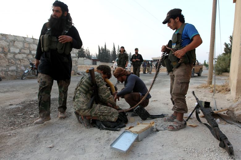 Rebel fighters prepare their weapons in an artillery academy of Aleppo Syria