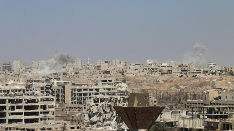 Smoke billows from buildings during an operation by Syrian government forces to retake control of the rebel-held district of Leramun on the northwest outskirts of Aleppo