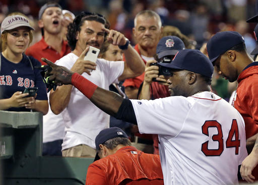 Boston Red Sox designated hitter David Ortiz points to fans while going into the dugout after the Red Sox defeated the Minnesota Twins in a baseball game at Fenway Park