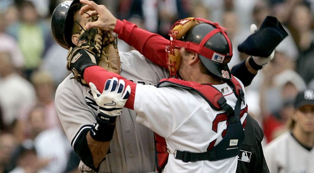 Boston Red Sox catcher Jason Varitek right strikes New York Yankees batter Alex Rodriguez at Fenway Park in Boston. The two fought after Rodriguez was hit by a pitch by Red Sox pitcher Bronson Arroyo. The Red Sox won 11-10 with a 9th-inning game winn