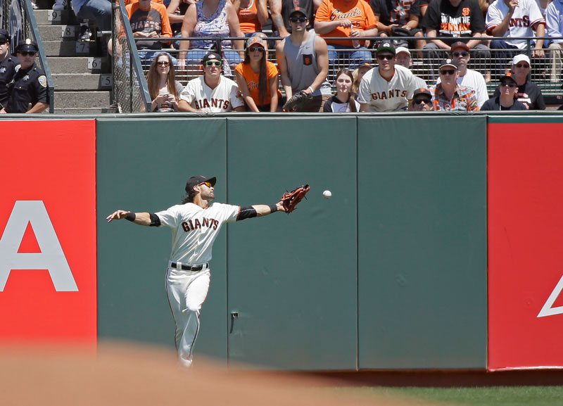 Angel Pagan misses a fly ball hit by the Cincinnati Reds’ Eugenio Suarez in the fifth inning Wednesday’s game. Pagan was charged with what turned out to be a costly error on the play