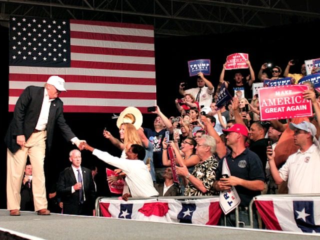 DIMONDALE MI- AUGUST 19 Republican presidential nominee Donald Trump shakes hands with supporters on his way to the podium to speak at a campaign rally