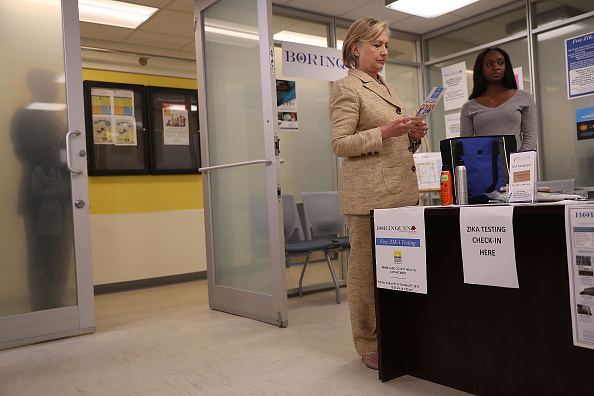 Democratic presidential nominee Hillary Clinton stands at the Zika testing check-in desk at the Borinquen Health Care Center