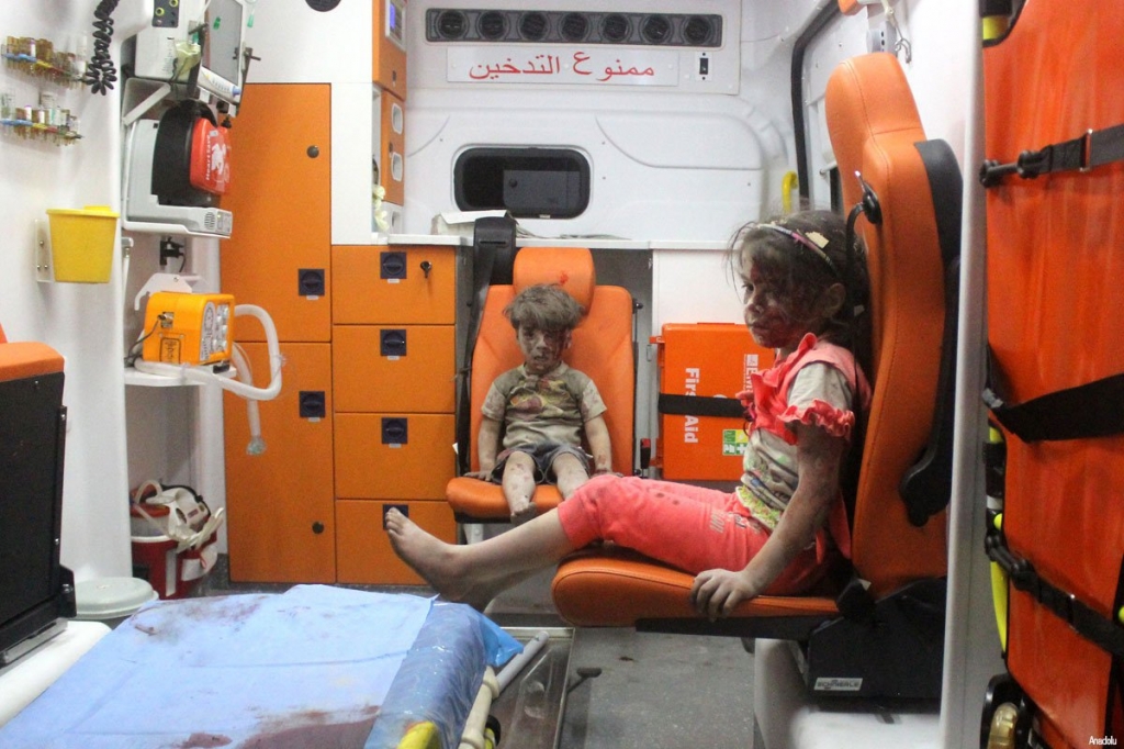 5 year old Omran Daqneesh sitting at the back of an ambulance with a young girl both of whom were rescued from the rubble after an air strike in Aleppo Syria