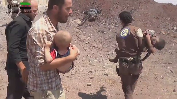 Rescuers carry children through rubble after an airstrike in Aleppo.               CBS News