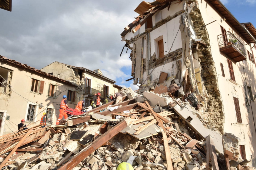 Rescuers clear debris while searching for victims in Arquata del Tronto Italy