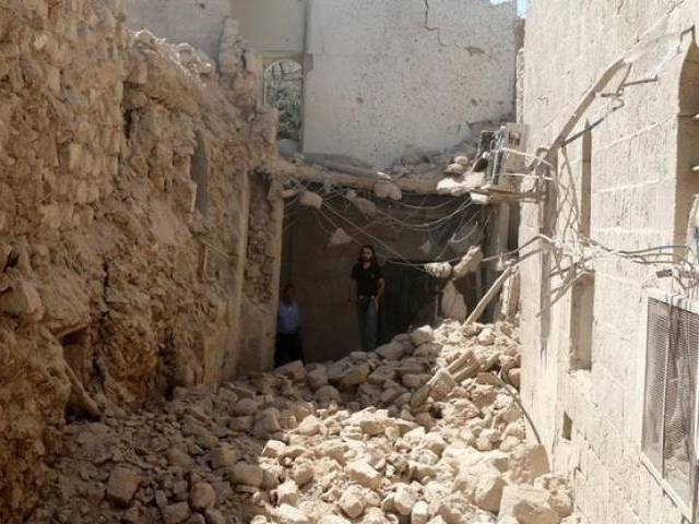 Residents inspect their damaged homes after an airstrike