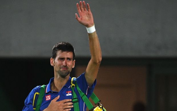 Serbia's Novak Djokovic waves to the crowd with tears in his eyes after losing his men's first round singles tennis match against Argentina's Juan Martin Del Potro at the Olympic Tennis Centre of the Rio 2016 Olympic Games in Rio de Janeiro