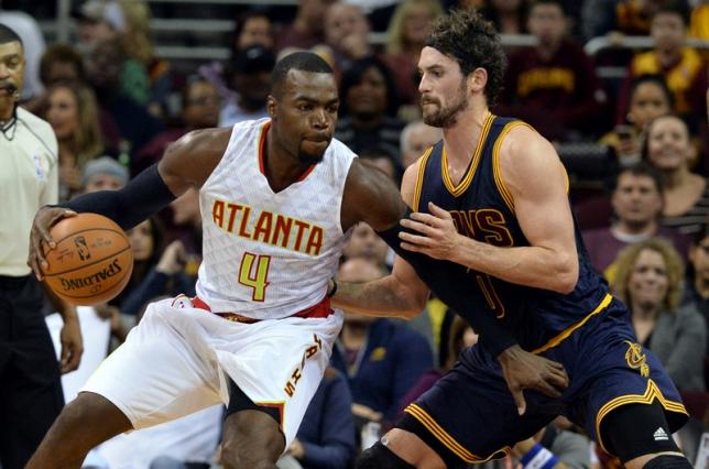 The Atlanta Hawks Paul Millsap being defended by Kevin Love of the Cleveland Cavaliers