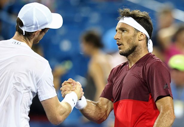 Andy Murray, left greets Juan Monaco