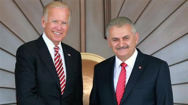 Turkish Prime Minister Binali Yildirim and US Vice President Joe Biden shake hands as they pose for