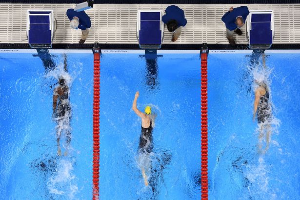 Simone Manuel of the United States and Canada's Penny Oleksiak touch the wall to win gold in the Women's 100m Freestyle Final