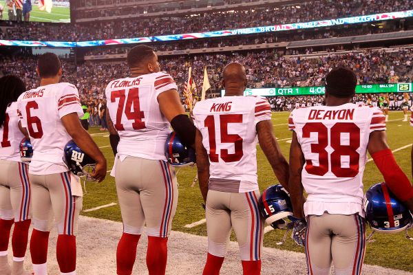 Giants players line up for the national anthem