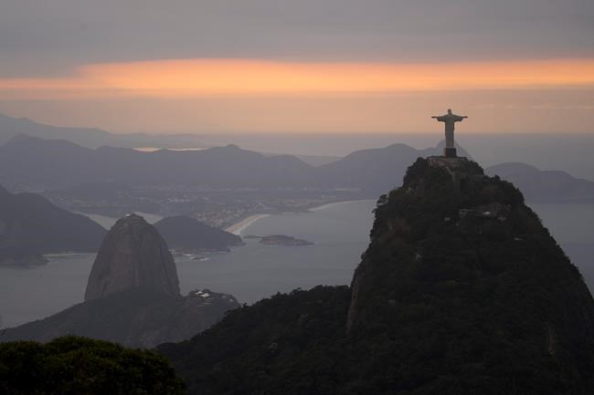 The Christ the Redeemer statue and Sugar Loaf mountain stand as the sun rises in Rio de Janeiro Brazil Thursday Aug. 4 2016. The 2016 Summer Olympics is scheduled to open Aug. 5