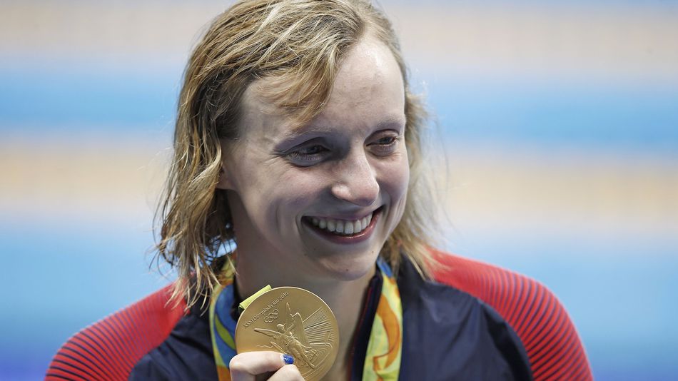 United States Katie Ledecky holds up her gold medal in the women's 800-meter freestyle medals ceremony during the swimming competitions at the 2016 Summer Olympics