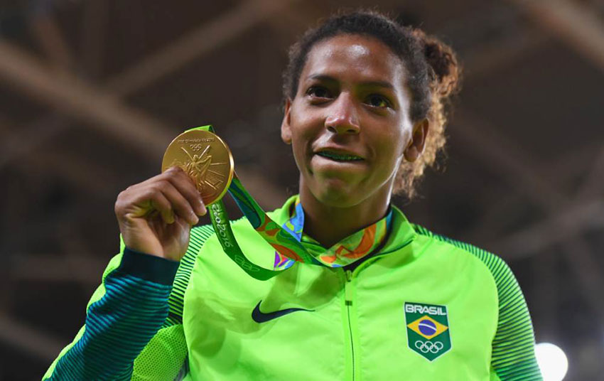 Silva poses with her gold medal after beating the Mongolian world number one in front