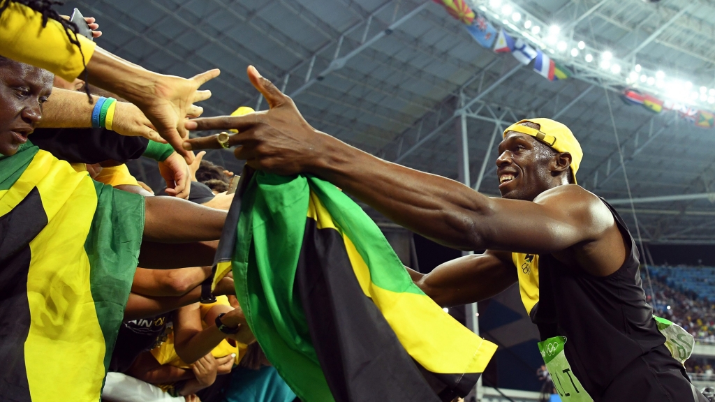 Usain Bolt of Jamaica celebrates with fans after winning the men's 100m final of the Rio 2016 Olympic Games Athletics Track and Field events at the Olympic Stadium in Rio de Janeiro Brazil 14 August 2016