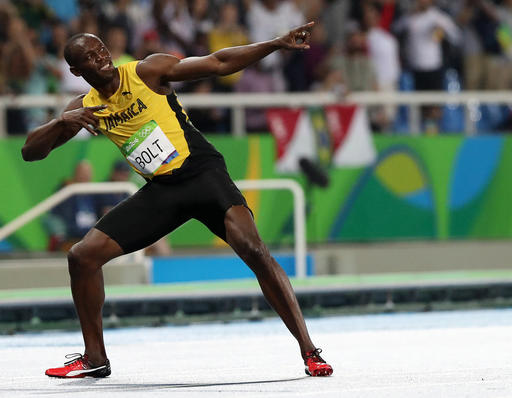 Usain Bolt from Jamaica celebrates after crossing the line to win the gold medal in the men's 200-meter final during the athletics competitions of the 2016 Summer Olympics at the Olympic stadium in Rio de Janeiro Brazil Thursday Aug. 18 2016. (AP Phot