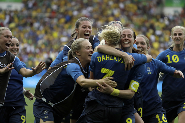 Sweden's players celebrates at the end of the semi-final match of the women's Olympic football tournament between Brazil and Sweden at the Maracana stadium