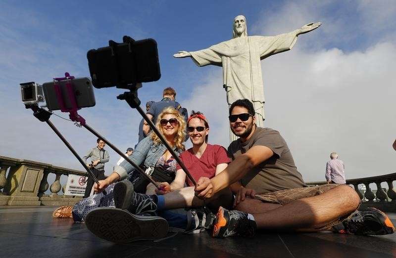 2016 Rio Olympics- Christ the Redeemer- 30/07/2016. Tourists pose for selfies in front of Christ the Redeemer. REUTERS  Kai Pfaffenbach