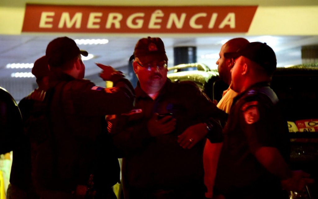 Fellow police officers wait for information about National Force member Helio Vieira in front of the Salgado Filho hospital in Rio where Vieira underwent a four-hour surgery after being shot in the head