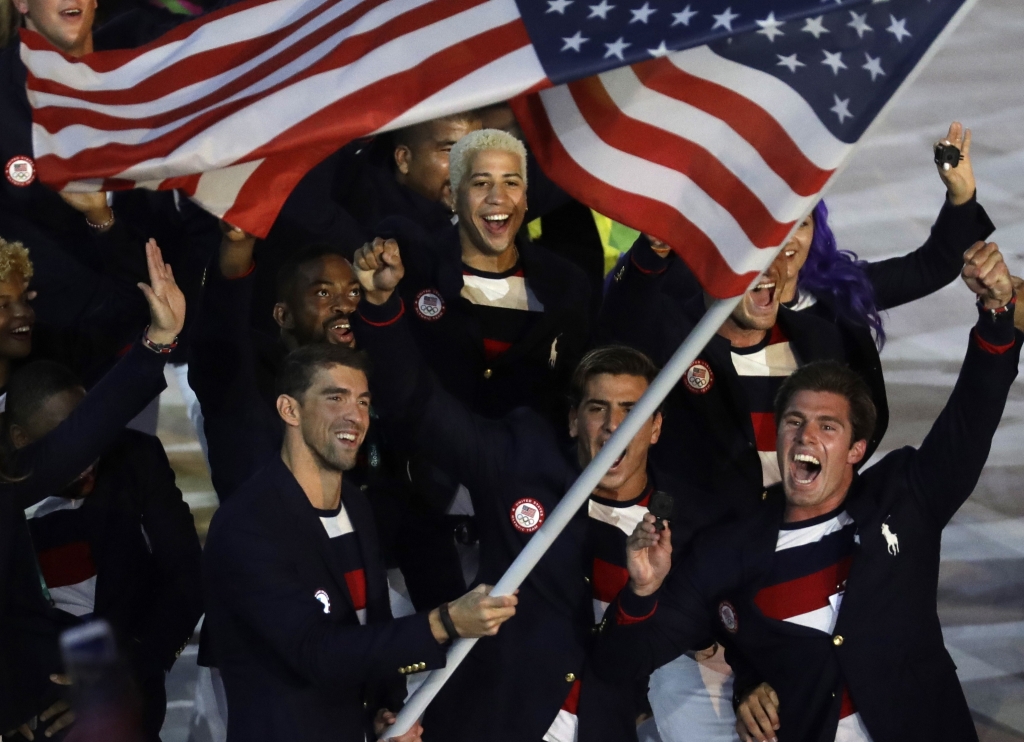 Michael Phelps carries the flag of the United States during the opening ceremony for the 2016 Summer Olympics in Rio de Janeiro Brazil