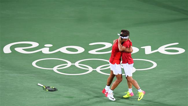 Spain's Rafael Nadal and Spain's Marc Lopez celebrate after winning the men's doubles final tennis match against Romania's Florin Mergea and Romania's Horia Tecau at the Olympic Tennis Centre of the Rio 2016 Olympic Games in Rio de Jan